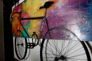 Mexican artist Ivan Guaderrama often incorporates antiques into his work. Here he attached an old-fashioned bicycle to a painting for an interesting effect. © Mariah Baumgartle, 2011