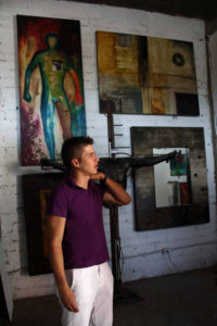 Mexican artist Ivan Guaderrama discusses some of his pieces, which range from small, delicate items to wall-sized paintings like the one behind him.© Mariah Baumgartle, 2011