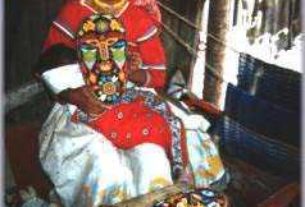 Huichol girl making a mask