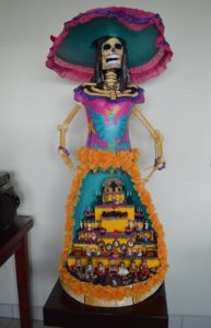 A colorful Catrina figure with Day of the Dead altar dedicated to women by Silvia Celida García Ramírez of Mexico City. Photo © Leigh Thelmadatter, 2019