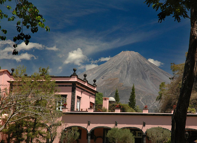 Mexico's Volcan de Fuego seems to loom right above the luxury resort of Hacienda San Antonio just down the road from the crater lake © John Pint, 2012