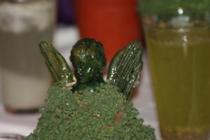 An angel figurine sprouts chia leaves, representing resurrection and new life © Tara Lowry, 2014