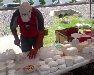 This tianguis booth specializes in dairy products with clotted cream in covered plastic glasses, many kinds of cheese and a bowl of golden milk custard. These traveling Mexican markets offer an astonishing variety of mercandise. © Daniel Wheeler, 2009