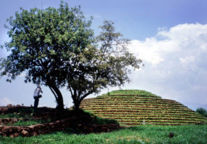 A visitor snaps a photo atop one of the platforms around the circular pyramid at Mexico's Guachimontones archeological site. In ancient times, these platforms doubled as sites for conducting municipal business as well as entrances to tombs which were open to visitors. © John Pint, 2009