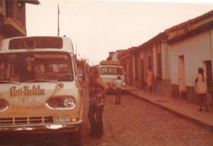 The familiar chimes of the ice-cream van permeated the adobe walls most afternoons. Tamara’s sister Jill buys a paleta in front of their home on Guadalupe Victoria at Nicolas Bravo, just behind the church. The white van in the background is their mother’s van. ﻿Photo by Beverly Johnson. All rights reserved.