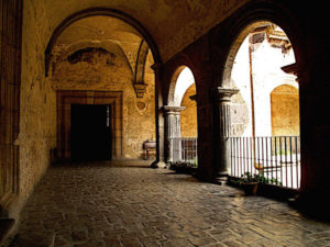 Our departure is imminent as we approach the entryway to the grand staircase that will lead us downwards and out of the Ex-Convento in Yuriria, Michoacan. The beautiful old convent dates from the 16th century and is one of the largest in Mexico. This original photograph forms part of the Olden Mexico collection. © Darian Day and Michael Fitzpatrick, 2010