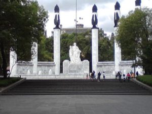 The massive Altar a la Patria, inaugurated in 1952, standing at the principal entrance to Mexico City's Chapultepec Park. Its six enormous columns each represent one of the Niños Heroes. Chapultepec Castle can be seen in the background. David Wall, 2013