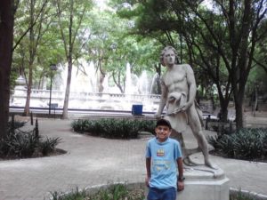 The author's son, David Wall, poses with a statue of David in Mexico City's Chapultepec Park © Lilia Wall, 2013