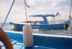 Fishing boats with captains like this are plentiful and reasonably priced on Isla Mujeres © Louie Frias, 2013