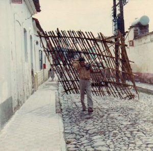 ﻿And what is this being carried up the street towards the plaza? Well, he has to get his hand-made gate back home somehow, and maybe his donkey has wandered off! ﻿Photo by Janis Carter, Tamara’s best friend, who lived on that street at the time (1965). All rights reserved.