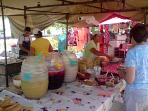 Jars of icy agua fresca -- fresh fruit drinks -- site between fried tacos to go and an array of homemade salsas. This tianguis sets up every Thursday in Guadalajara near the Plaza Mexico shopping center. © Daniel Wheeler, 2009