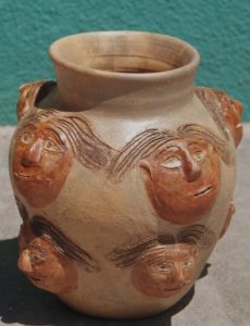 Oaxaca ceramicist Dolores Porras creates a pot with faces in different terracotta tones. © Arden Aibel Rothstein and Anya Leah Rothstein, 2007