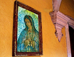 Just off the Vasco de Quiroga Square in Patzcuaro, a passageway opens onto a secluded courtyard of one of the square's magnificent old homes. Here, the Virgin of Guadalupe watches over a tranquil fountain and graceful colonnades. This original photograph forms part of the Olden Mexico collection. © Darian Day and Michael Fitzpatrick, 2009