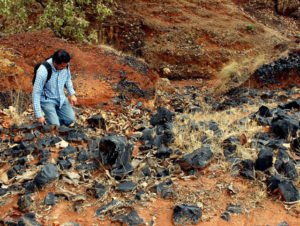 Archeologist Rodrigo Orozco inspecting one of thousands of old obsidian quarries located west of Guadalajara, Mexico. Ancient miners rarely had to dig deeper than a meter to find all the obsidian they needed. © John Pint, 2009