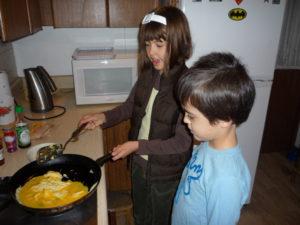 Ana Cristina Wright Ramirez prepares huevos revueltos for a Mexican brunch with the help of her 4-year-old brother, Santiago James. © Anthony Wright, 2009