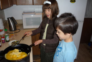 Ana Cristina Wright Ramirez prepares huevos revueltos for a Mexican brunch with the help of her 4-year-old brother, Santiago James. © Anthony Wright, 2009