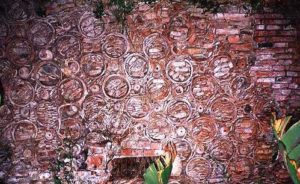 Pottery and brick shards innovatively 'repair' the ancient wall of the Hacienda of Nogueras.