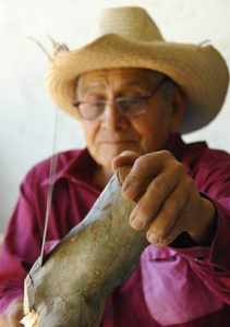 The Oaxacan artisan uses a machete to achieve the alebrije's basic shape, then switches to finer knives to carve the finished piece. © Alan Goodin 2007