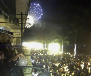 Fireworks celebrate the New Year on the malecon in Puerto Vallarta. The beach walk is packed with happy tourists while onlookers wear hats that say "Happy New Year." © Daniel Wheeler, 2009