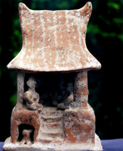 A clay model shows the style of buildings constructed on the platforms around the pyramids of Guachimontones. Dogs, often shown in these models, were thought to carry the souls of the dead to the next world. © John Pint, 2009