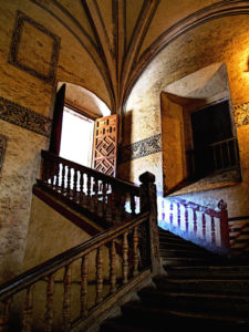 A shadowed staircase rises from the lower arcade to the upper level of the Ex-Convento de San Pablo Apostol in Yuriria, Michoacan. It is magnificent, almost as though it soars through the air. The beautiful old convent dates from the 16th century and is one of the largest in Mexico. This original photograph forms part of the Olden Mexico collection. © Darian Day and Michael Fitzpatrick, 2010