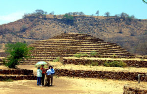 The hillside in the background was terraced in ancient times and may have been used by crowds of people to watch the dances and ball games which took place here. Music played at the Guachimontones archeological site pyramids can be heard clearly from this vantage point. © John Pint, 200
