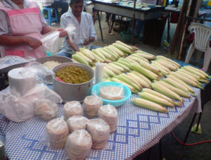 Corn on the cob and bags of freshly cut corn kernels flank a pot of cooked nopalitos -- the nutritious pads of the prickly pear cactus. In the foreground, pre-cooked masa shells in plastic bags are ready to go back on the griddle and beome sopes with delicious fillings and toppings. © Daniel Wheeler, 2009