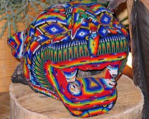 A Huichol jaguar head covered with intricate beadwork. The beads are applied one at a time with a needle, and are held in place with beeswax. © Kinich Ramirez, 2006