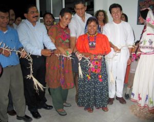 Cutting the "ribbon" to open the The Wixarika World: A Visit to the Huichol Lands exhibit. © Kinich Ramirez, 2006