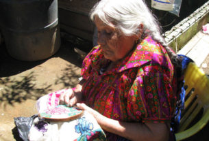 Hermelinda Reyes Ascenio works on a guanengo, or traditional blouse, in the patio of her granddaughter's Cocucho, Michoacan home. © Travis Whitehead, 2009