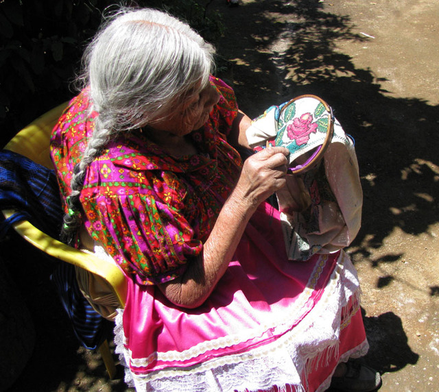 Mexico's bright sunshine entices Hermelinda Reyes Ascenio to work outdoors. The 84-year-old native of Cocucho, Michoacan, is one of the region's most skilled embroidery artists. © Travis Whitehead, 2009