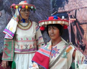 A Huichol couple wears embroidered cotton clothing and straw hats with tassels. © Kinich Ramirez, 2006