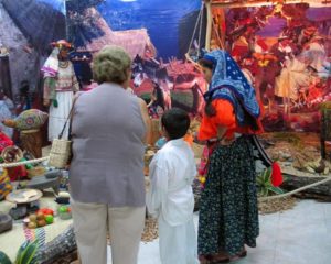 Huichol representatives admire the Wixarika World exhibit with signage in Spanish, English and Maya languages. © Kinich Ramirez, 2006