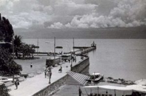 Lake Chapala, Mexico, in August 1965. Buses brought weekend visitors to Chapala pier where they strolled in the sunshine or sat in deckchairs in front of the BeerGarden enjoying the view. Photo in family collection of Marsha Sorensen; all rights reserved.