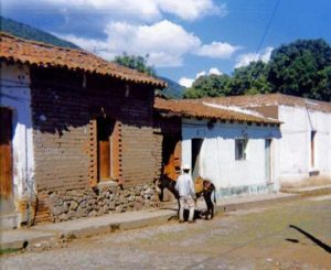 Few homes in Ajijic needed garages in the early 1970s since the preferred means of transport had four legs as in this view of a typical village street. Photo in family collection of Marsha Sorensen; all rights reserved.