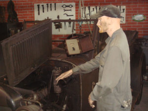 In Mexico City's Automobile Museum, a mannequin mechanic tools around with his 1921 Reo. © Anthony Wright, 2009