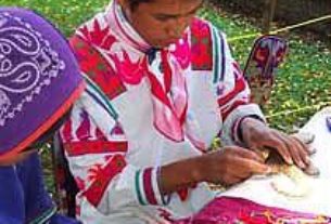 Each piece of beaded art is made by individually placing the beads into wax and pine resin spread on a wooden base.