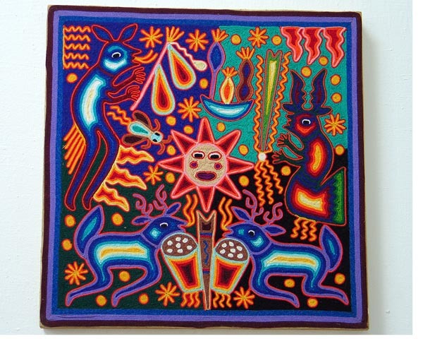This nearika -- Huichol yarnwork "votive" painting -- depicts the sacred blue deer, who also appear as shamans on eac side of the composition. © Kinich Ramirez, 2006