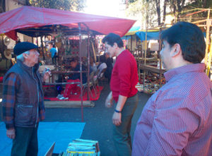 La Lagunilla Antiques Market operators Carlos Villasena (far right) and Raul Torres (right) confer with regular customer, veteran actor Jose Carlos Ruiz (star of the tough 1976 prison drama El Apando), over the team's latest acquisitions.