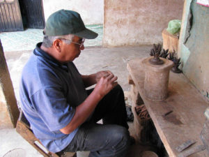 José María Alejos Madrigal works on an espiga for a clay pot in his workshop in San José de Gracia.