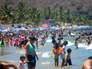 Vacationers enjoy the warm Pacific waves at Los Ayala on Mexico's Nayarit Riviera. © Christina Stobbs, 200