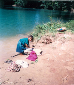 A girl washes clothes in a river in rural Chiapas. © Henry Biernacki, 2012