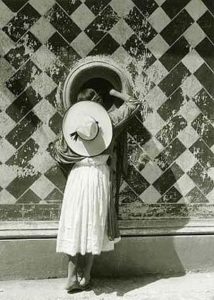 The Daughter of the Dancers (1933) A young woman looks through a mysterious portal in a wall. She is dressed in a Mexican costume. One foot is placed awkwardly atop the other as is sometimes seen in early pre-Columbian carvings. Perhaps she is Mexico searching for its past through the hole in the well-worn wall.