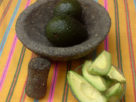 A good way to get the seed out of the avocado without much effort is by letting the blade of a knife fall into it and twisting to release the seed from the creamy pulp. © Daniel Wheeler, 2009