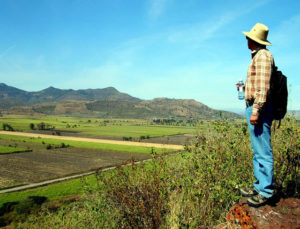 An archeologist looks out over what was once Lake Magdalena from the top of former Itztlitlan Island, thought to have been the largest obsidian workshop in the world. The 53-kilometer stretch of highway from Tala to San Marcos in the state of Jalisco boasts many fascinating sites. © John Pint, 2009
