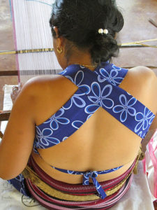 Women of Pinotepa de Don Luis, Oaxaca, wear skirts, called pozahuanacos, with horizontal stripes of red, black, blue and purple. They wear a halter-style apron on top, in response to modern public reaction to their bare breasted custom. © Geri Anderson, 2011