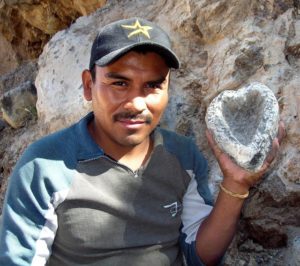 At his family's quarry near Lake Cajititlan, Victor Cocula demonstrates the procedures for transforming a basalt rock into a heart-shaped mortar. © John Pint, 2012
