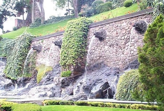 Waterworks in the gardens provide background for family photos. Here the water flows out of Aztec looking figures protruding from the wall.
