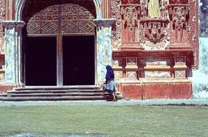 A native of Landa enters the Mission from the grass-covered courtyard.