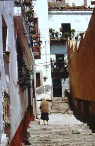 Typical narrow passageways serve as the main streets linking this city, confined to a cramped, steep valley.